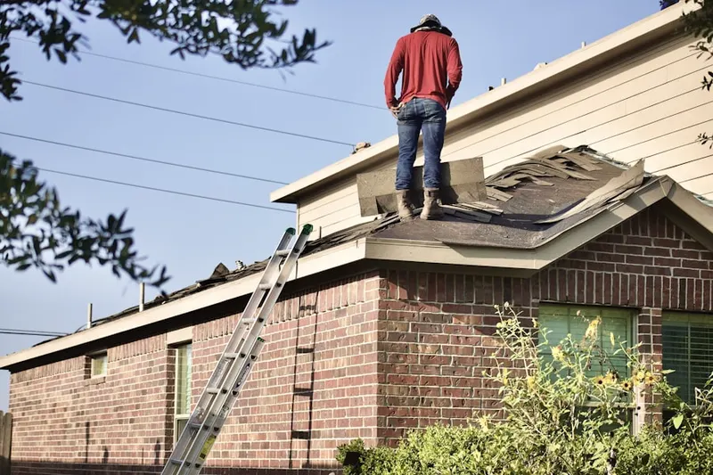 Professional roofer working on a residential roof in Sequim